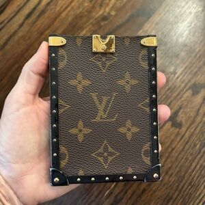 Broken part of authentic Louis Vuitton Eye Trunk iPhone case in Monogram canvas